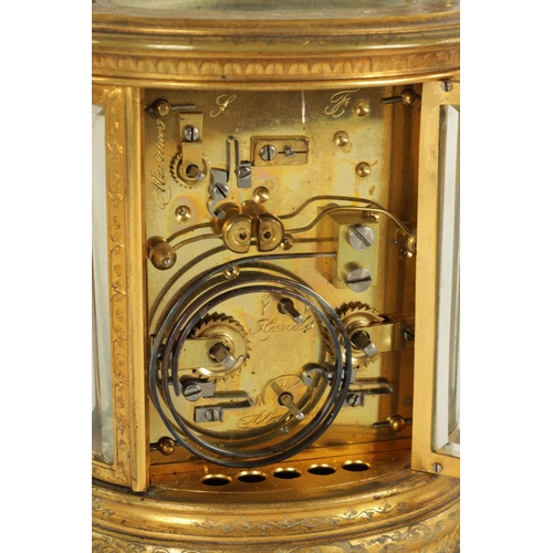 691 - A LATE 19TH CENTURY OVAL ENGRAVED GILT BRASS CARRIAGE CLOCK REPEATER the foliate engraved case enclo... 