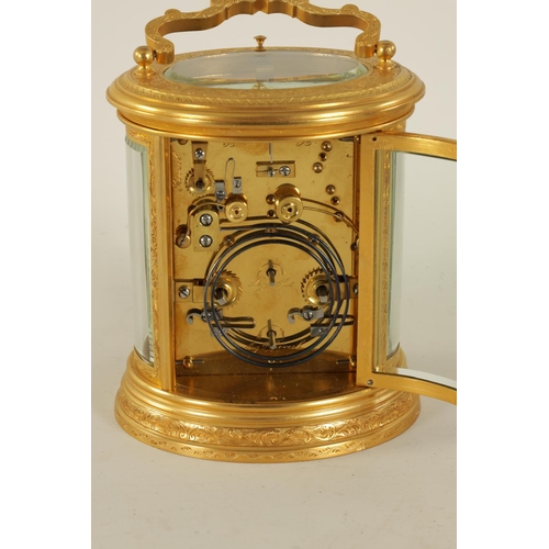 696 - A LATE 19TH CENTURY OVAL ENGRAVED GILT BRASS REPEATING CARRIAGE CLOCK the foliate engraved case encl... 