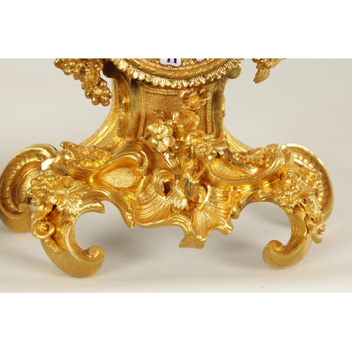 718 - A SMALL MID 19TH CENTURY FRENCH ORMOLU MANTLE CLOCK the Rococo style case with leaf and berry decora... 