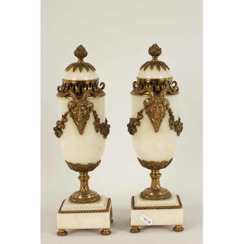 562 - A PAIR OF 19TH CENTURY CARRARA MARBLE AND ORMOLU MOUNTED CASOLETTES with detachable finials, peirced... 