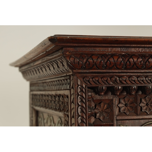 175 - AN EARLY 19TH CENTURY ANGLO-INDIAN HARDWOOD SIDE CABINET with panelled sides and detailed carved dec... 