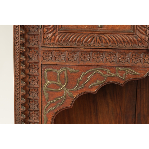 175 - AN EARLY 19TH CENTURY ANGLO-INDIAN HARDWOOD SIDE CABINET with panelled sides and detailed carved dec... 