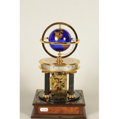 1005 - A ROYAL GEOGRAPHICAL SOCIETY MILLENNIUM CLOCK having a rotating cobalt blue glass globe and moon wit... 