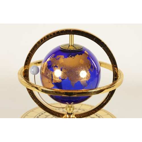 1005 - A ROYAL GEOGRAPHICAL SOCIETY MILLENNIUM CLOCK having a rotating cobalt blue glass globe and moon wit... 