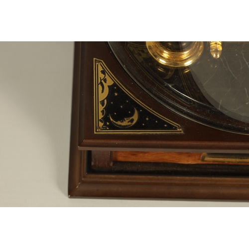 1005 - A ROYAL GEOGRAPHICAL SOCIETY MILLENNIUM CLOCK having a rotating cobalt blue glass globe and moon wit... 