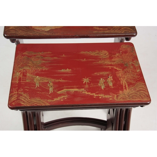 102 - A SET OF 19TH CENTURY SCARLET LACQUER CHINOISERIE DECORATED NEST OF TABLES comprising four graduated... 