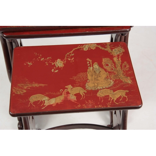 102 - A SET OF 19TH CENTURY SCARLET LACQUER CHINOISERIE DECORATED NEST OF TABLES comprising four graduated... 