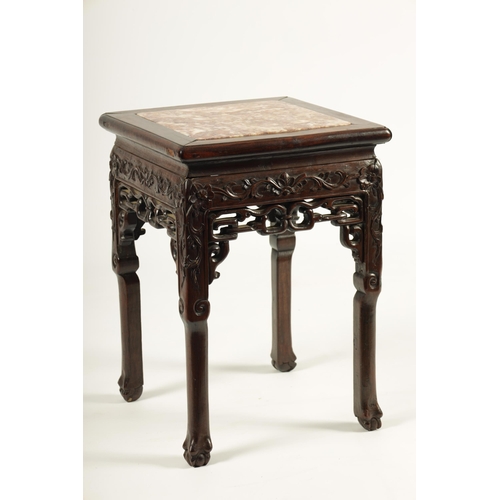 111 - A 19TH CENTURY CHINESE HARDWOOD JARDINIERE TABLE with inset pink marble top above a floral and leafw... 