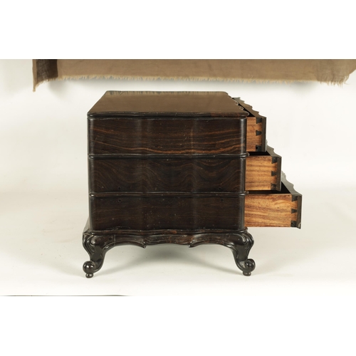 117 - A GOOD 19TH CENTURY ANGLO INDIAN EBONY MINIATURE COMMODE of all-round wavey edge form with moulded d... 