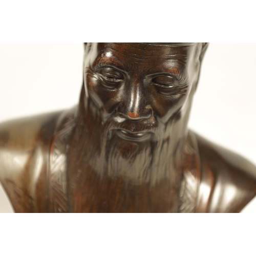 119 - A LATE 19TH CENTURY JAPANESE PATINATED BRONZE BUST ON STAND modelled as an Emperor mounted on an ebo... 