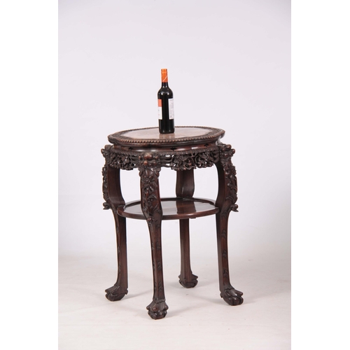 120 - A 19TH CENTURY PROFUSELY CARVED CHINESE HARDWOOD CIRCULAR JARDINIERE STAND with marble inset top and... 