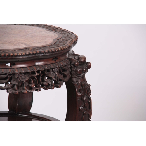 120 - A 19TH CENTURY PROFUSELY CARVED CHINESE HARDWOOD CIRCULAR JARDINIERE STAND with marble inset top and... 