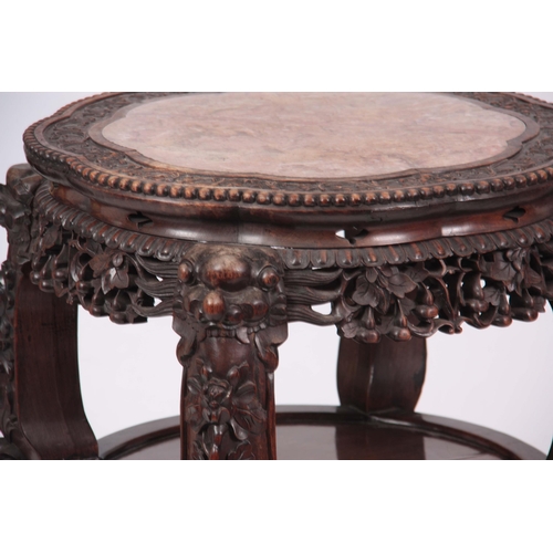 120 - A 19TH CENTURY PROFUSELY CARVED CHINESE HARDWOOD CIRCULAR JARDINIERE STAND with marble inset top and... 