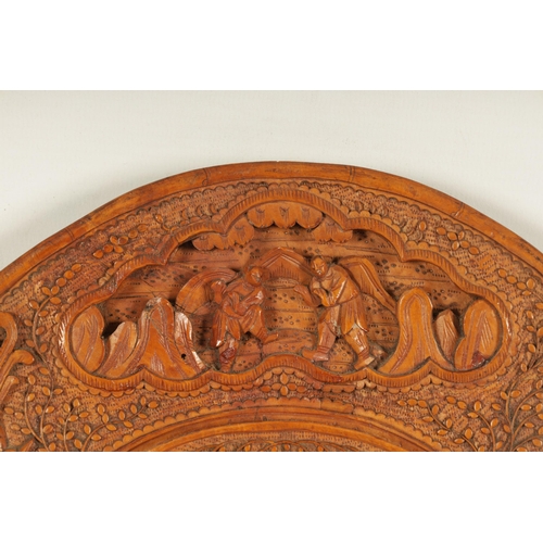 129 - A PAIR OF LATE 19TH CENTURY CHINESE CARVED BOXWOOD OVAL MIRRORS the relief carved frames decorated w... 