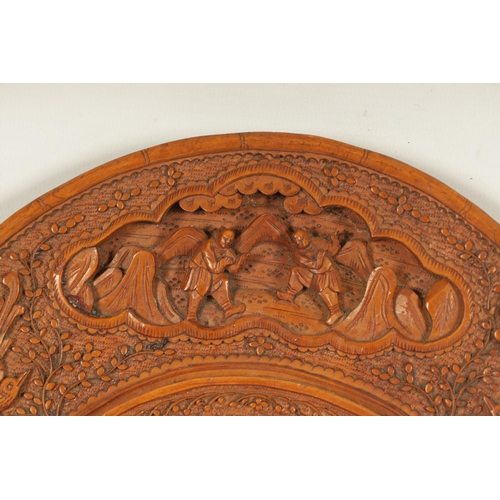 129 - A PAIR OF LATE 19TH CENTURY CHINESE CARVED BOXWOOD OVAL MIRRORS the relief carved frames decorated w... 