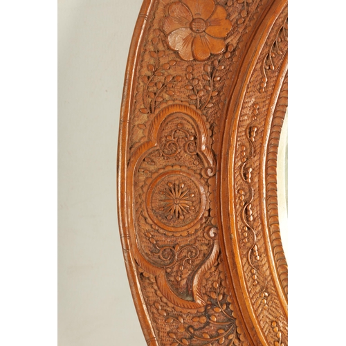 129 - A PAIR OF LATE 19TH CENTURY CHINESE CARVED BOXWOOD OVAL MIRRORS the relief carved frames decorated w... 