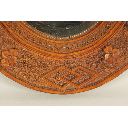 129 - A PAIR OF LATE 19TH CENTURY CHINESE CARVED BOXWOOD OVAL MIRRORS the relief carved frames decorated w... 