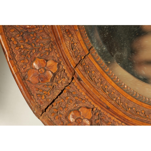 129 - A PAIR OF LATE 19TH CENTURY CHINESE CARVED BOXWOOD OVAL MIRRORS the relief carved frames decorated w... 