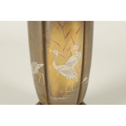 132 - A JAPANESE MEIJI PERIOD GOLD AND SILVER INLAID BRONZE VASE the segmented body depicting wading egret... 