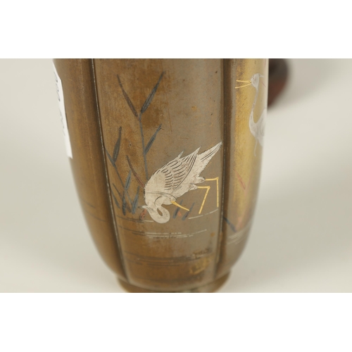 132 - A JAPANESE MEIJI PERIOD GOLD AND SILVER INLAID BRONZE VASE the segmented body depicting wading egret... 