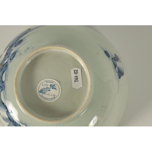 134 - AN 18TH CENTURY CHINESE BLUE AND WHITE FOOTED BOWL FROM THE NANKING CARGO decorated with tree-lined ... 