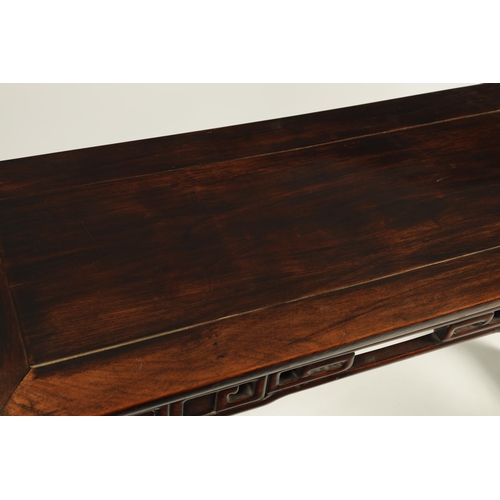 135 - A 19TH CENTURY CHINESE HARDWOOD ALTAR TABLE OF GOOD COLOUR AND PATINA with cleated top above a pierc... 