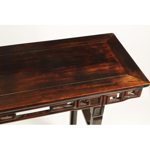 135 - A 19TH CENTURY CHINESE HARDWOOD ALTAR TABLE OF GOOD COLOUR AND PATINA with cleated top above a pierc... 