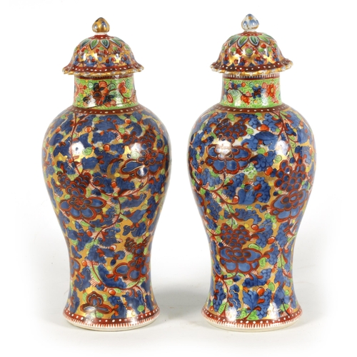 138 - A PAIR OF CHINESE KANGXI PERIOD INVERTED BALUSTER VASES AND COVERS with 19th century colourful all-o... 