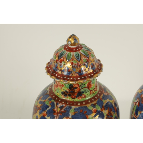 138 - A PAIR OF CHINESE KANGXI PERIOD INVERTED BALUSTER VASES AND COVERS with 19th century colourful all-o... 