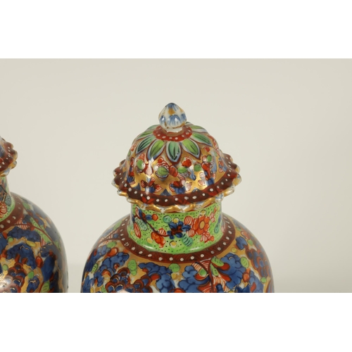 138 - A PAIR OF CHINESE KANGXI PERIOD INVERTED BALUSTER VASES AND COVERS with 19th century colourful all-o... 