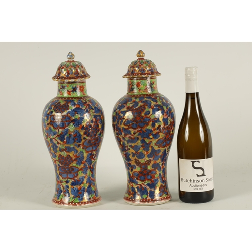 138 - A PAIR OF CHINESE KANGXI PERIOD INVERTED BALUSTER VASES AND COVERS with 19th century colourful all-o... 