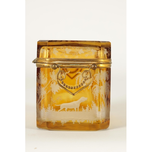 14 - A 19TH CENTURY BOHEMIAN AMBER GLASS OVERLAY CASKET with etched decoration depicting Stags amongst tr... 