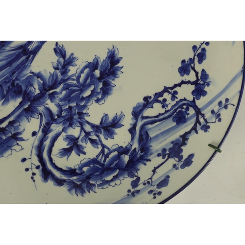 147 - A JAPANESE MEIJI PERIOD BLUE AND WHITE CHARGER with bird and tree decoration in a landscape setting.... 