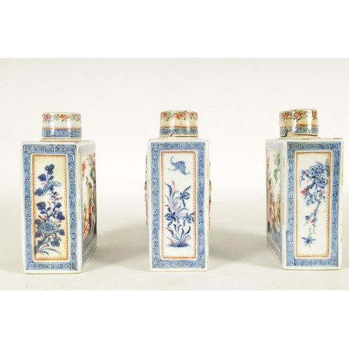 152 - A SET OF THREE 19TH CENTURY CHINESE FAMILLE ROSE PORCELAIN TEA CADDIES of rectangular form with cyli... 