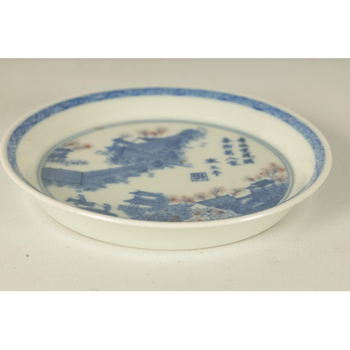 153 - A 19TH CENTURY CHINESE BLUE AND WHITE SMALL DISH decorated a fenced and pagoda landscape with script... 