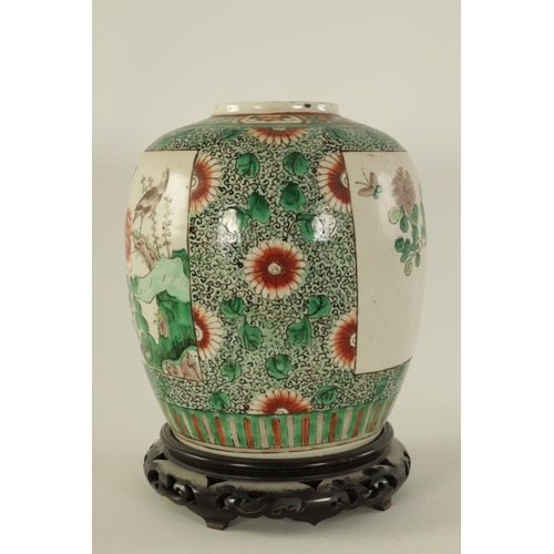 157 - A 19TH CENTURY CHINESE FAMILLE VERTE GINGER JAR ON STAND with panelled floral decoration depicting c... 