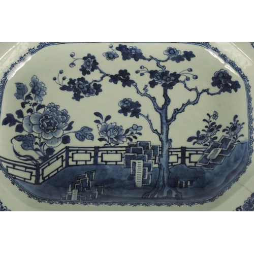 162 - AN 18TH CENTURY CHINESE BLUE AND WHITE CLIPPED RECTANGULAR DISH with fenced garden scene to the cent... 