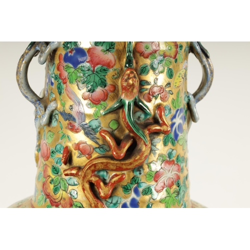 164 - A LARGE 19TH CENTURY CHINESE FAMILLE ROSE PORCELAIN VASE with gilt floral ground enclosing two large... 