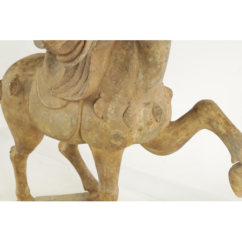 176 - A CHINESE EARTHENWARE MODEL OF A TANG HORSE with polychrome slip decoration (53cm high 55cm wide )