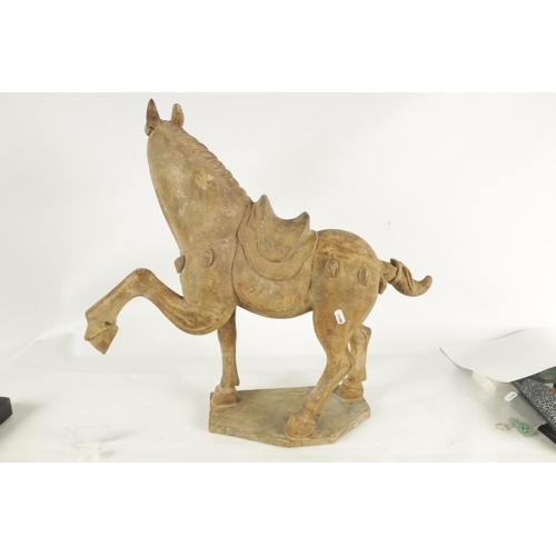 176 - A CHINESE EARTHENWARE MODEL OF A TANG HORSE with polychrome slip decoration (53cm high 55cm wide )