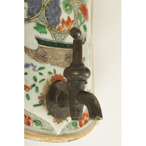 183 - A CHINESE FAMILLE VERTE KANGXI PERIOD SHAPED WATER CISTERN decorted with sprays of flowers (34cm hig... 