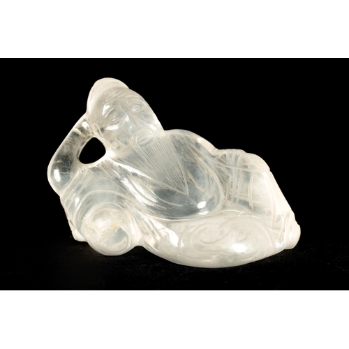 185 - A CHINESE CARVED ROCK CRYSTAL FIGURE depicting a reclining sage. (7.5cm wide 5cm high)