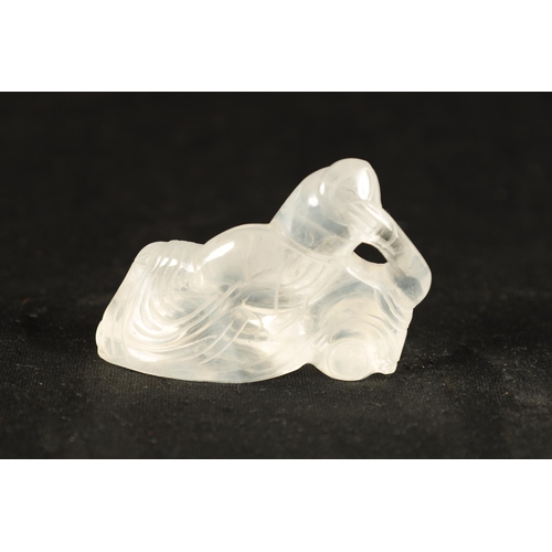 185 - A CHINESE CARVED ROCK CRYSTAL FIGURE depicting a reclining sage. (7.5cm wide 5cm high)