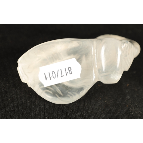 185 - A CHINESE CARVED ROCK CRYSTAL FIGURE depicting a reclining sage. (7.5cm wide 5cm high)