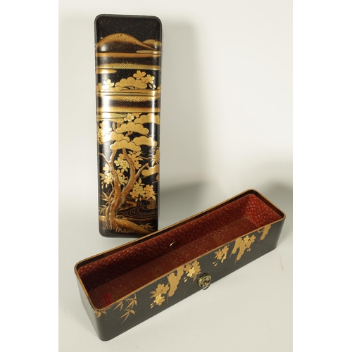 191 - A JAPANESE MEIJI PERIOD BLACK LACQUERWORK SCROLL BOX with raised gilt decoration of prunus trees in ... 