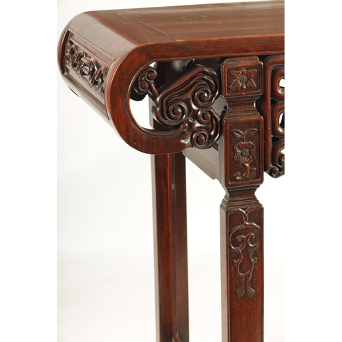 192 - A 19TH CENTURY CHINESE HARDWOOD ALTAR TABLE the cleated top with carved scrolled ends and cut-out fr... 