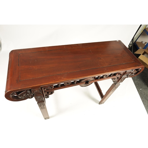 192 - A 19TH CENTURY CHINESE HARDWOOD ALTAR TABLE the cleated top with carved scrolled ends and cut-out fr... 