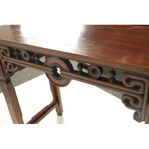 192 - A 19TH CENTURY CHINESE HARDWOOD ALTAR TABLE the cleated top with carved scrolled ends and cut-out fr... 