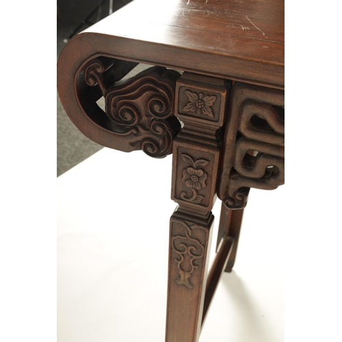 192 - A 19TH CENTURY CHINESE HARDWOOD ALTAR TABLE the cleated top with carved scrolled ends and cut-out fr... 