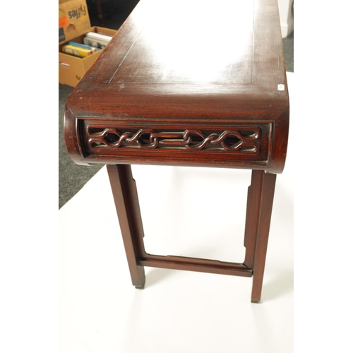 192 - A 19TH CENTURY CHINESE HARDWOOD ALTAR TABLE the cleated top with carved scrolled ends and cut-out fr... 